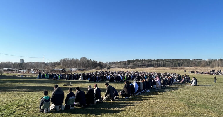 män som ber på grönt fält