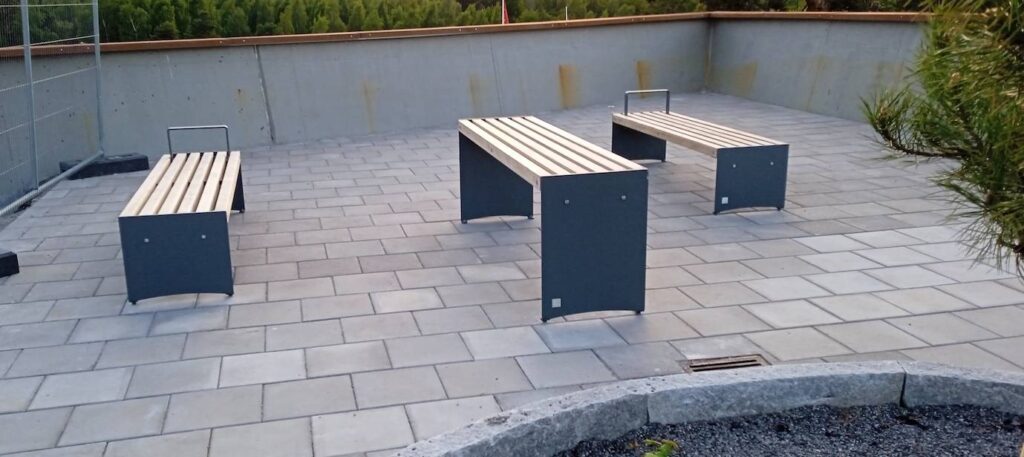 Bänkar och bord i trä och metall, ett slags konstinstallation.