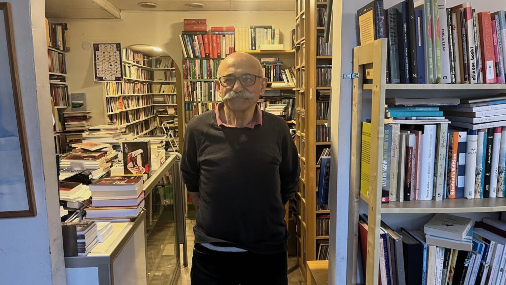 Nemat Alimoradi står i sin bokhandel på Helsingforsgatan i Akalla.