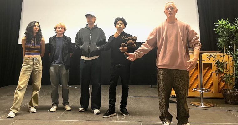 Fem personer på scenen i Rinkeby Folkets Hus. Fyra skådisar i fimen Flaggan och regissören,